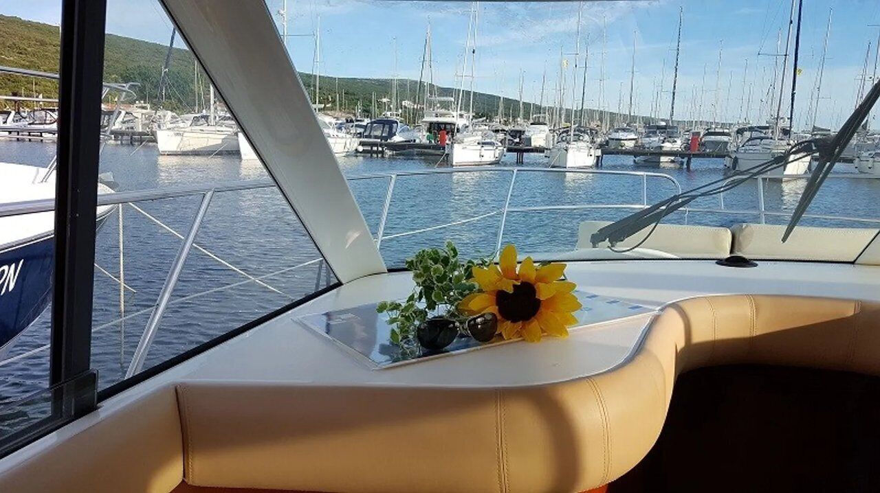 A boat interior with a view of a marina.