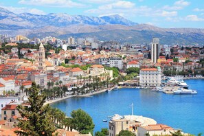A coastal cityscape with historic buildings, a marina, and mountains in the background. - Sun-Kissed Sailing Adventure in Split, Croatia (Split)