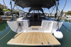 A boat deck with a name 'Vekenega,' a steering wheel, and a canopy. - Sun-Kissed Sailing Adventure in Zadar, Croatia (Zadar)