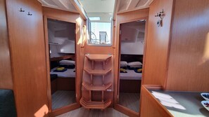 A compact RV interior with two bunk beds, a central storage unit, and a small window. - Sun-kissed Sailing Adventure in Split-Dalmatia, Croatia (Trogir)