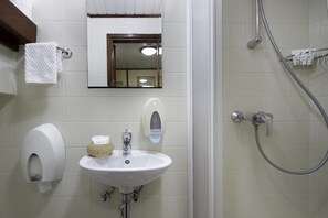 A bathroom with a sink, hand dryer, and a shower. - Sun-Kissed Sailing Adventure in Split, Croatia (Split)
