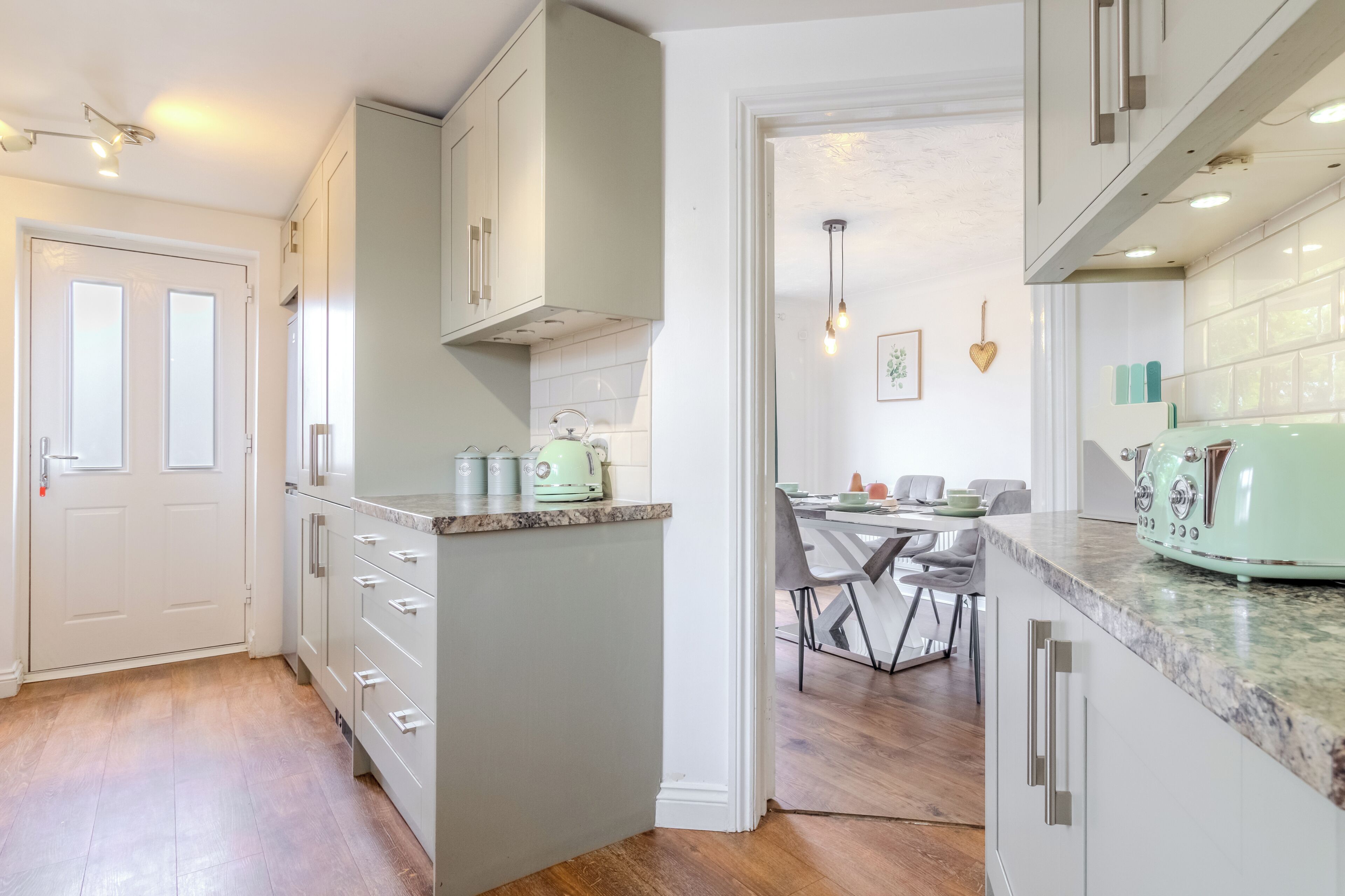 Bright modern kitchen with stylish finishes and open dining access