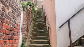 A narrow brick stairway leading to a building entrance.