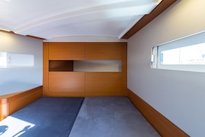 A compact interior with a bunk bed, wooden storage compartments, and a window for natural light. - Sun-Kissed Sailing Adventure in the Ionian Islands, Lefkada (Lefkada)