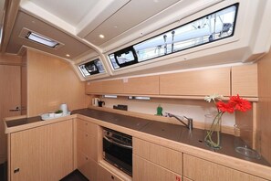 A compact galley with a skylight, a stove, and a small oven. - Sun-Kissed Sailing Adventure in Zadar, Croatia (Biograd na moru)