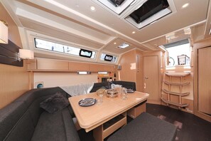 A compact interior with a dining area, seating, and built-in storage.
