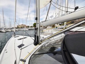 A marina with multiple sailboats docked.