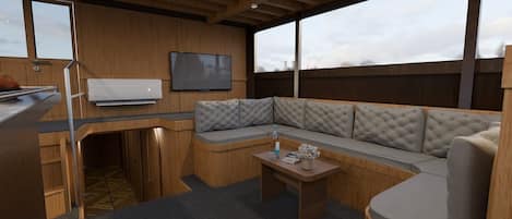 A modern interior with a wooden ceiling, a large window, a sofa, a table, and a flat-screen TV.