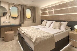 A modern hotel room with a large bed, bedside tables, a vanity with a mirror, and a window with curtains. - Sun-Kissed Sailing Adventure in Split, Croatia (Split)