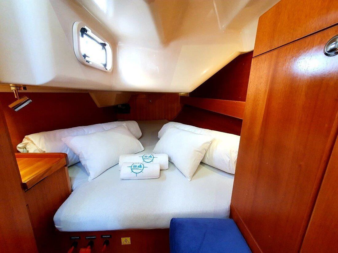 A compact cabin with a bed, a small table, and a window.