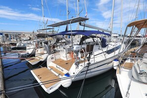A marina with multiple sailboats docked, featuring wooden decks and various amenities. - Sibenik Sun-Kissed Sailing: A Luxurious Beach Experience in Croatia (Murter)