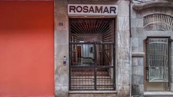 Entrada de un edificio con un letrero que dice 'ROSAMAR' y el número '12' sobre la puerta.