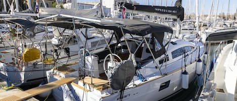 A marina with multiple sailboats docked, including one with 'Lady Blue' and 'IMPRESSION 40.1' visible on its side.