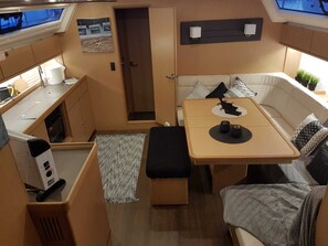 A compact RV interior with a kitchenette, a dining area, and a seating space. - Sun-Kissed Sailing Adventure in the Ionian Islands, Lefkada (Lefkada)