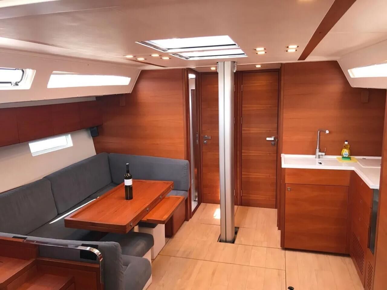 A compact interior with a dining area, a kitchenette, and a seating area.