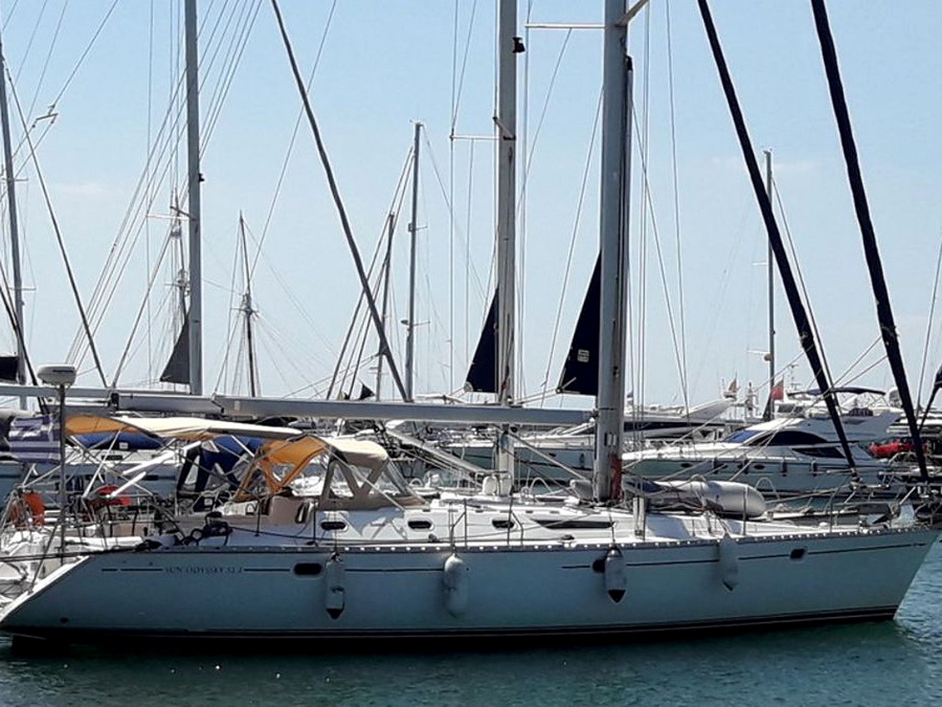 A marina with multiple sailboats docked.