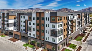 A multi-story residential building with a modern design, featuring balconies, large windows, and a flat roof. - Landing Amazing 1bd, Game Room, Gym (Salt Lake City)