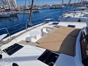 A marina with boats docked, a clear sky, and buildings in the background. - Sun-Kissed Sailing Adventure in the Majestic Islas Baleares (Sant Antoni de Portmany)