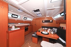 Een kleine kombuis met een eethoek, kitchenette en een zitje.