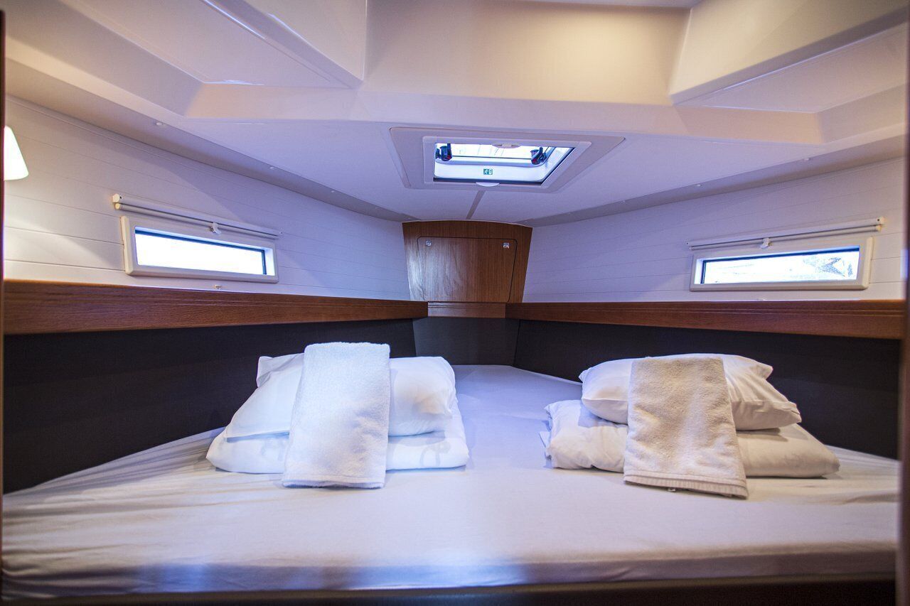 A cabin with bunk beds, a skylight, and a small window.