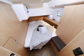 A compact, well-lit cabin with a bed, a small table, and a window. - Sun-kissed Sailing Adventure in Split-Dalmatia, Croatia (Trogir)