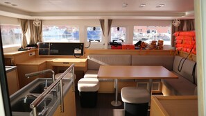 A compact galley with a sink, stove, and storage cabinets. - Sun-Kissed Sailing Adventure in Islas Baleares, Mallorca (Palma)