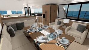 A modern yacht interior with a dining area, seating, and a view of the sea. - Sun-Kissed Sailing Adventure in the Ionian Islands, Lefkada (Lefkada)