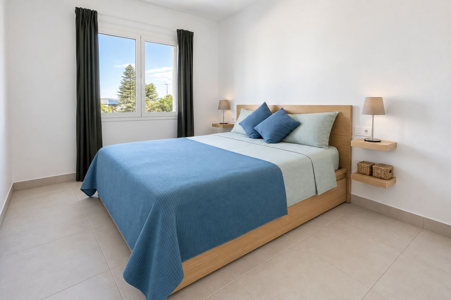 A modern bedroom with a bed, curtains, a window, and bedside lamps.