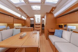 A modern RV interior with a dining area, seating, and a kitchen. - Sun-Kissed Sailing Adventure in Zadar, Croatia (Biograd na moru)