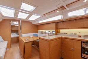 A compact galley with a sink, a small dining area, and a compact kitchenette. - Sun-Kissed Sailing Adventure in Zadar, Croatia (Biograd na moru)