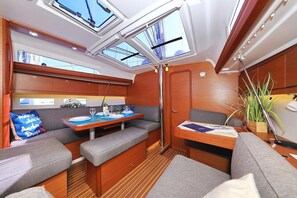 A yacht interior with a dining area, seating, and skylights. - Sun-kissed Sailing Adventure in Split-Dalmatia, Croatia (Trogir)
