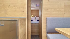 A compact room with a bed, a small desk, and a wardrobe. - Sibenik Sun-soaked Sailing: A Luxurious Croatian Voyage (Pirovac)
