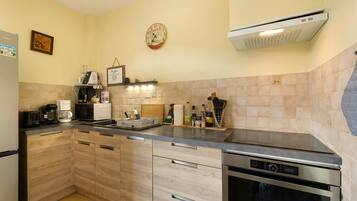 A kitchen with a built-in dishwasher, a coffee machine, and a microwave.