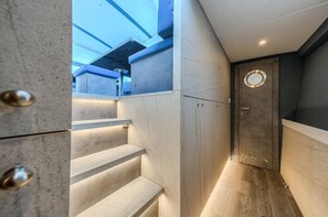 A modern interior with a staircase, a door with a circular window, and a skylight. - Sun-Kissed Sailing Adventure in Split, Croatia (Split)