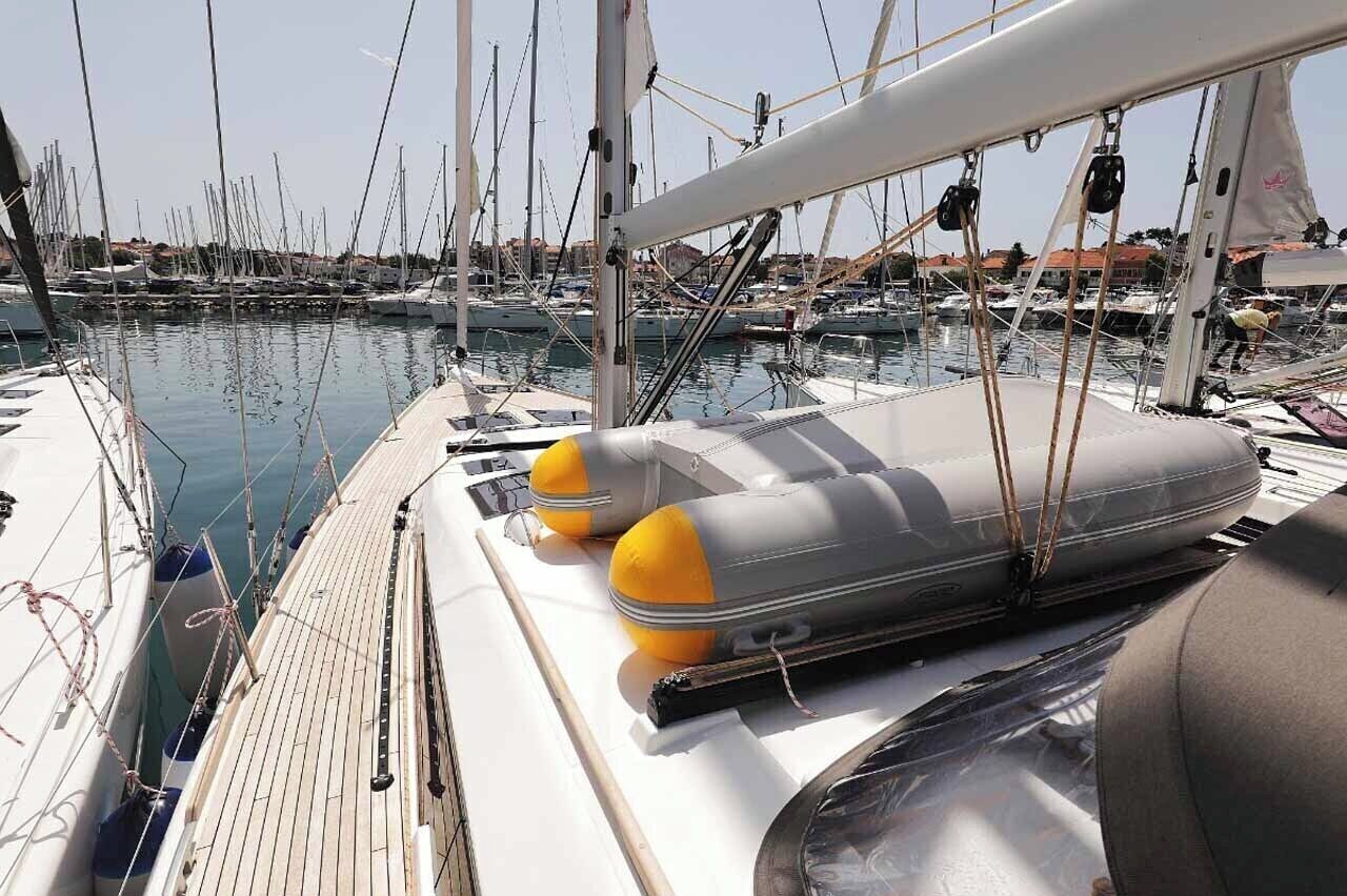 A marina with boats docked, a wooden deck, and a lifebuoy.