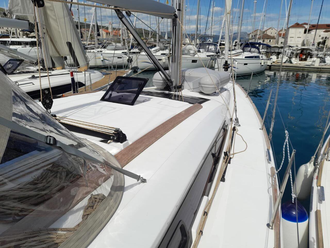 A marina with multiple sailboats docked.