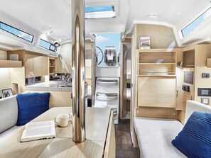 A compact, well-lit interior with a kitchenette, seating area, and a view through a door. - Sun-Kissed Sailing Adventure in the Ionian Islands, Lefkada (Lefkada)