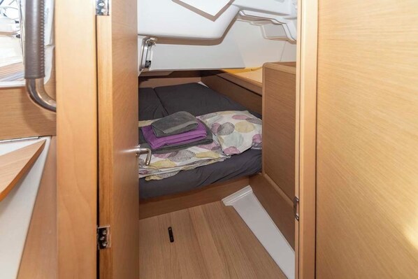 A compact, wooden interior with a bed, a small table, and a window. - Sun-Kissed Sailing Adventure in Islas Baleares, Mallorca (Portocolom)