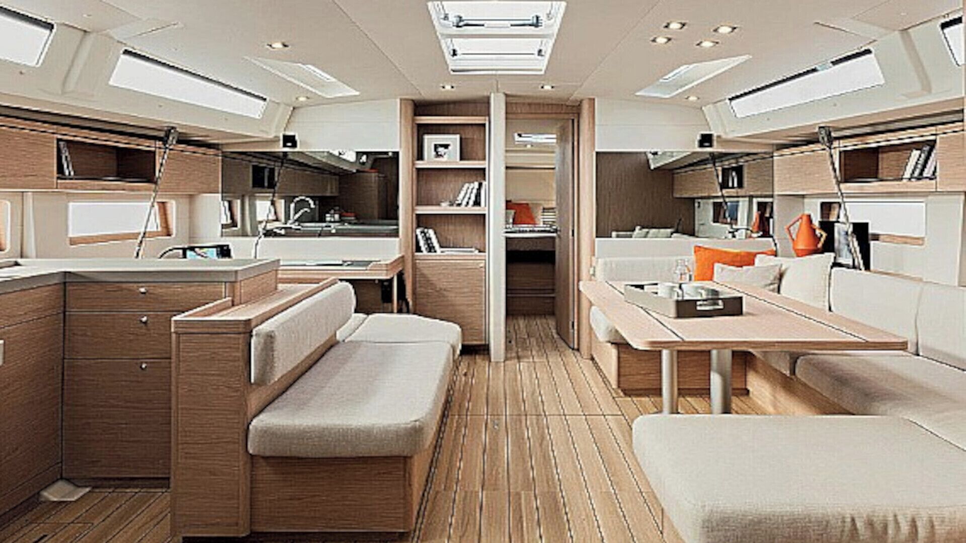 A compact, well-lit interior with a kitchenette, seating area, and storage cabinets.