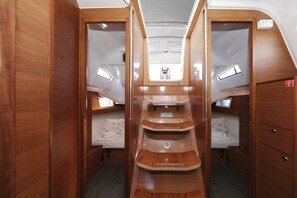 A compact RV interior with a central aisle, two sleeping areas, and a skylight. - Sibenik Sun-soaked Sailing: A Luxurious Croatian Voyage (Pirovac)
