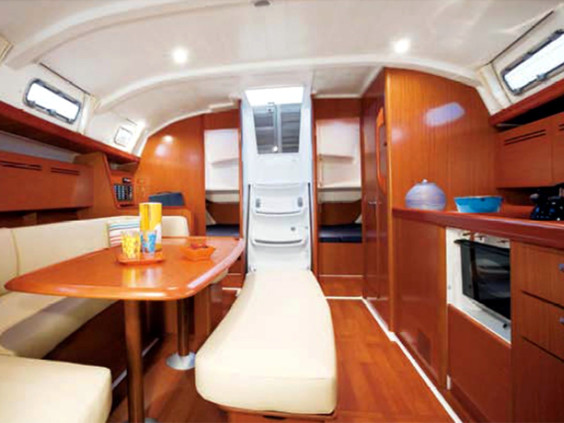 A compact kitchen with a bench, a small table, and a stove.