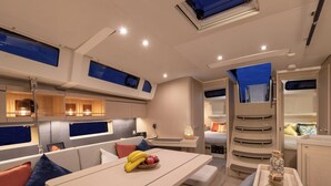A modern interior with a dining area, seating, and a kitchen.