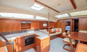 A compact galley with a sink, stove, and storage cabinets. - Sibenik Sun-soaked Sailing: A Luxurious Croatian Voyage (Pirovac)