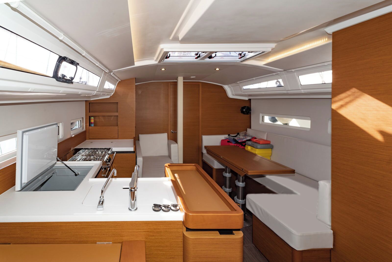 A compact galley with a sink, stove, and storage cabinets.