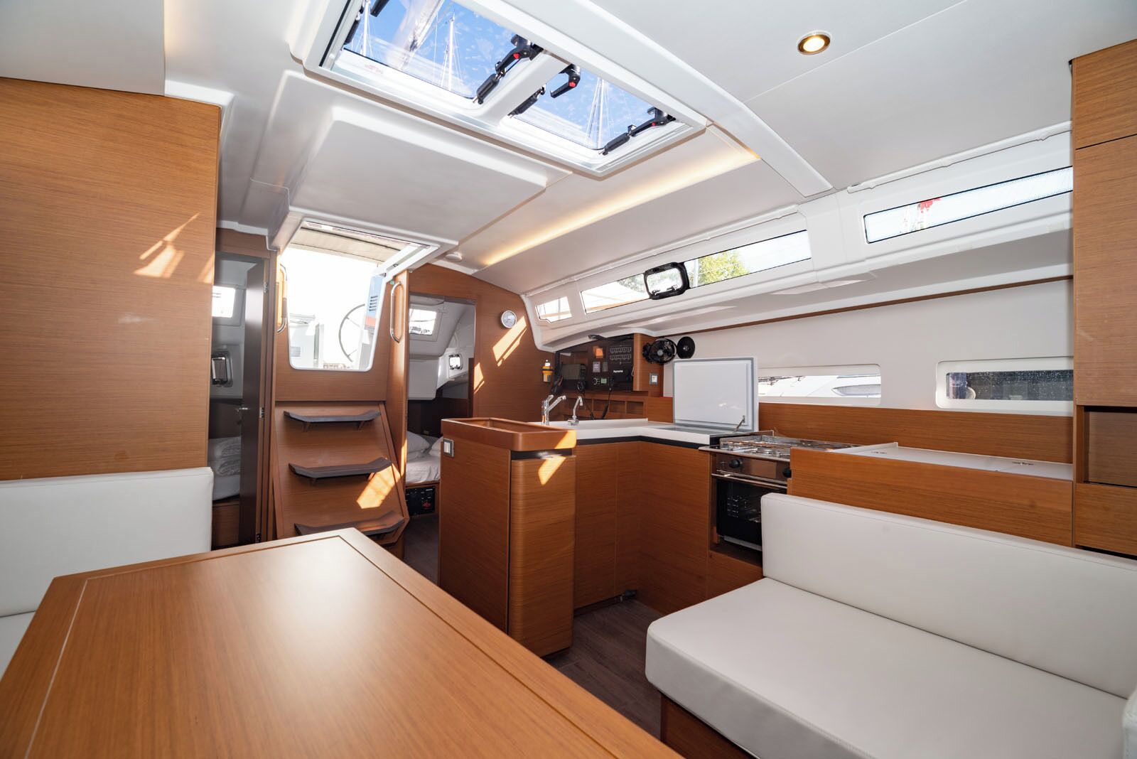 A compact, well-lit interior with a kitchenette, seating area, and a small dining table.