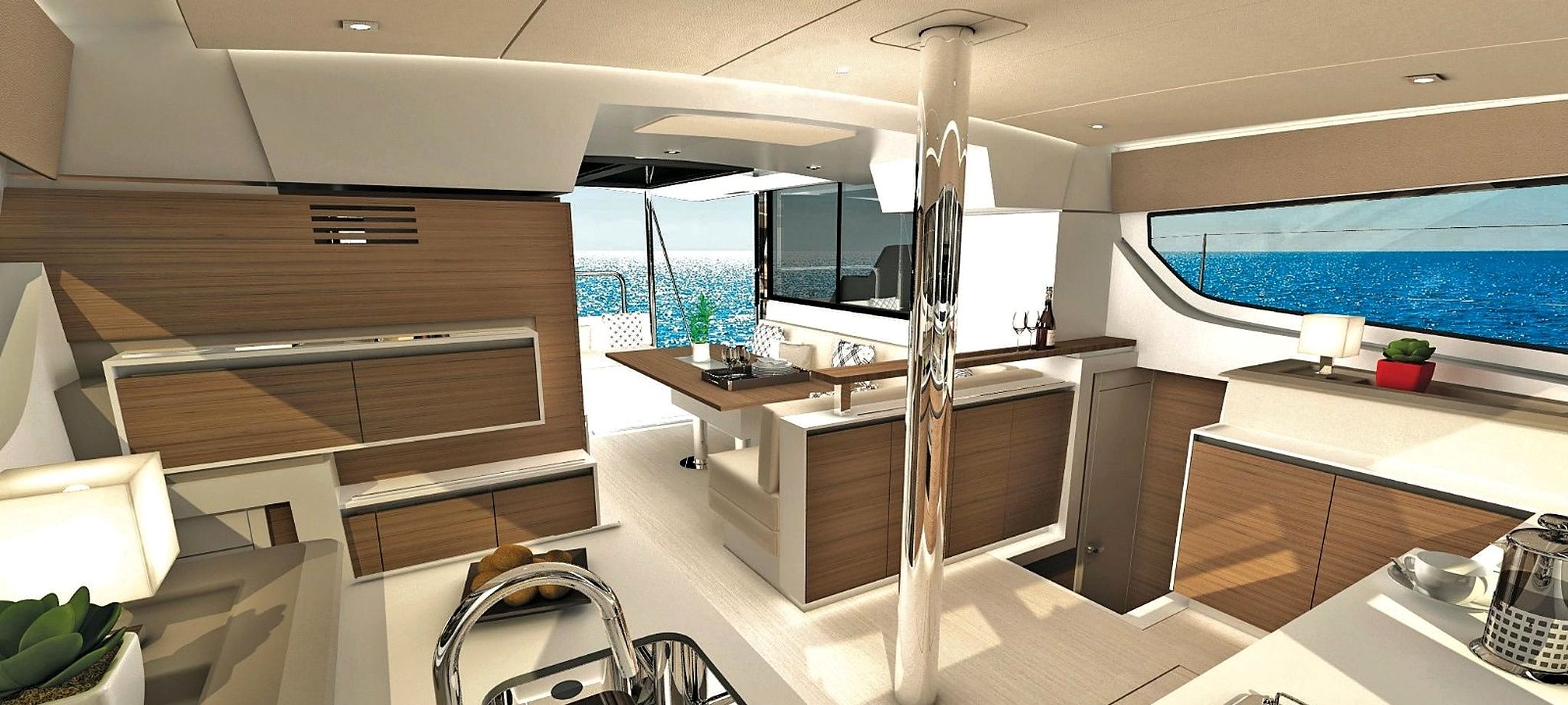 Une cuisine moderne dotée d’un îlot central, d’un coin repas et offrant une vue sur la mer.