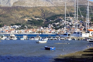 A coastal town with a marina filled with boats, a hillside with buildings, and a clear sky. - Sun-Kissed Sailing Adventure in Split-Dalmacia, Croatia (Podstrana)
