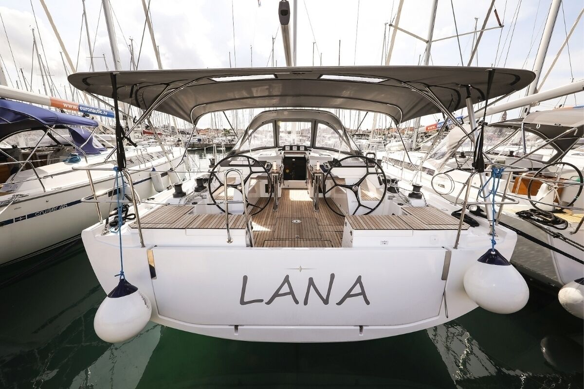 A marina with boats docked, including one named 'LANA'.