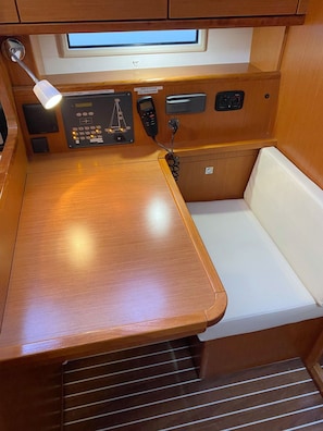 A compact kitchenette with a wooden countertop, a bench, and a small window above the sink. - Sun-Kissed Sailing Adventure in Istria, Croatia (Pula)