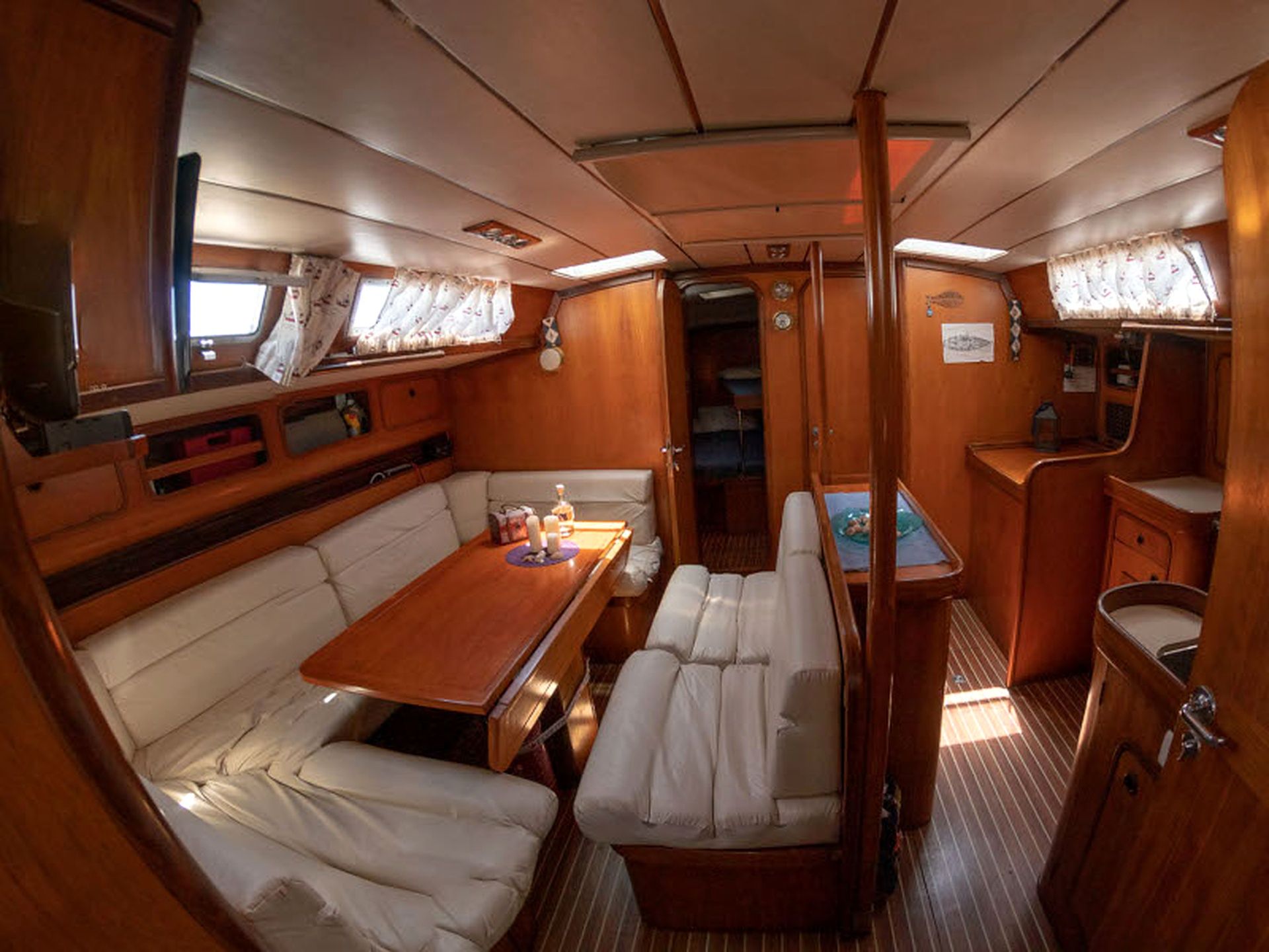 A compact, well-lit interior with a dining area, seating, and a small kitchenette.
